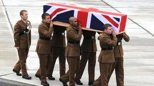 Rifleman Steel's being carried from the plane at Brize Norton