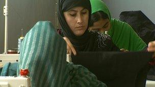 Women working at a textile factory near Kabul, alongside men