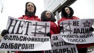 Communist Party activists in Moscow hold posters saying "No to vote-rigging", 2 December