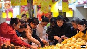 Shoppers select food at a supermarket in Anhui province (file image)