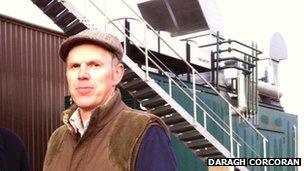 Farmer Neil Gemmel in front of his power system