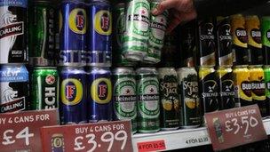 Cans of lager and cider on a shop shelf