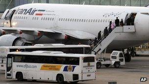 Iranian diplomatic staff board a plane at Heathrow Airport, in London