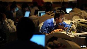 Indian information technology professionals work on their laptops during an Open Hack Day programme in Bangalore, July 2010