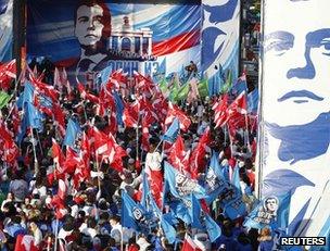 Russian government supporters rally under images of President Dmitry Medvedev on Red Square, 6 December