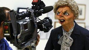 A cameraman films the Spitting Image puppet of Margaret Thatcher at the Rude Britannia: British Comic Art exhibition