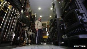 Costas Mitsionis, 42, stands among stoves inside his shop in Athens 23 November 2011.