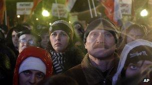 Russian opposition members listen during a rally in Moscow, 5 Dec 2011