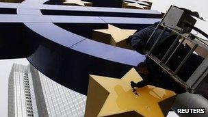 Worker clean the giant euro logo in front of the European Central Bank in Frankfurt. Photo: 6 December 2011