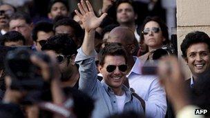 Tom Cruise waves to the crowd outside the Mumbai airport on Saturday 3 December 2011