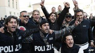 Italian policemen celebrate the arrest of Zagaria outside the police headquarters in Caserta