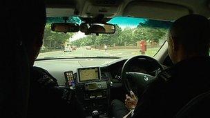 Officer drives a police car