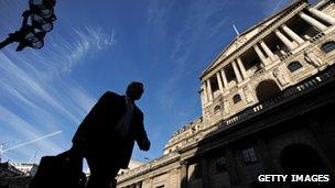 Man walking past Bank of England building