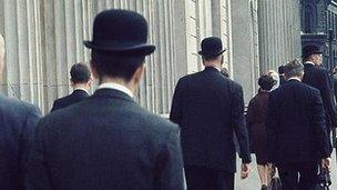 Office workers wearing bowler hats