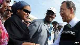 UN Secretary General, Ban Ki-moon (C) shakes hands with Somali women as he stands next to Somali Prime Minister Abide Mohamed Ali (R) after his arrival at Mogadishu"s Adan Abulle airport, Somalia on December 9, 2011.