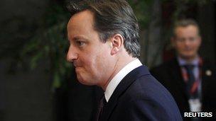 British Prime Minister David Cameron leaves the European Council headquarters in Brussels, 9 December