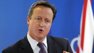 David Cameron speaks during a news conference in Brussels