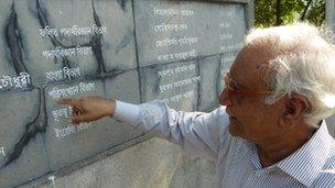 Professor Serajul Islam Choudhury points at names on a memorial wall at Dhaka University