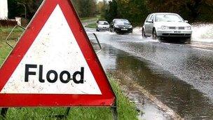 Flood sign on flooded road