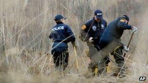 Suffolk County crime scene investigators use metal detectors to search a marsh for the remains of Shannan Gilbert 12 December 2011