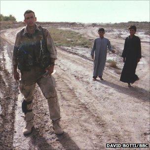 Marine stands in Iraq field