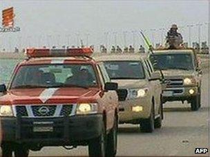 An image grab from Bahrain TV shows the vanguard of a contingent of Gulf troops arriving in Bahrain across a causeway from Saudi Arabia