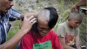 Police shave the hair of detained Indonesian punks at a police school in Aceh Besar in Aceh province