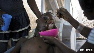 A Haitian teenager receiving treatment for cholera