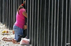 A couple shares a moment at the fence, 2008