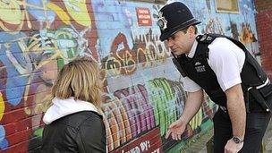 Police officer talking to girl