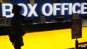 A Chinese woman checks what movies are playing at a cinema in Beijing, 8 November 2011