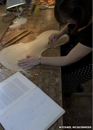 A woman working on her violin