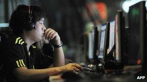 People using computers at an internet cafe in Beijing, 12 May 2011