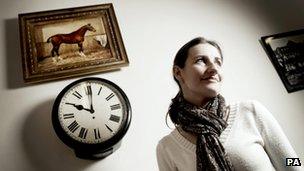 Ali Bannister beneath her painting in Iddesleigh village hall