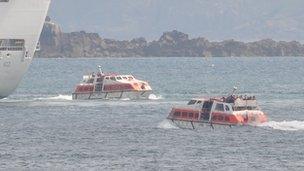 Tenders operating from a cruise ship moored off Guernsey with Sark in the background