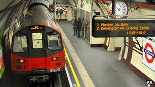 Tube train pulling into a station