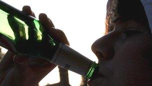 Boy drinking bottle of beer