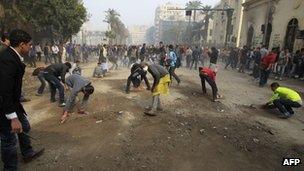 Egyptian protesters pick up debris in central Cairo