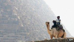 A camel-mounted Egyptian tourism policeman keeping vigil on the Giza plateau near Cairo. File photo
