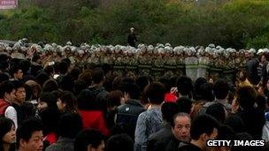Chinese residents confront riot police as they protest along a highway to demand the coal-fired plant be moved in Haimen township, in south China's Guangdong province on December 20, 2011.