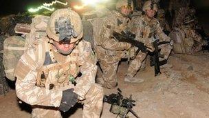 Members of the 1st Battalion The Royal Welsh wait as a helicopter lands as they prepare for Operation Moshtarak at Camp Bastion in Helmand Province on February 13, 2010,