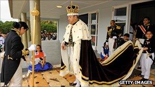 King in robes as part of crowning ceremony