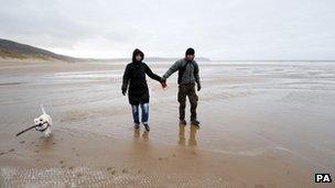 A couple on the beach at Woolacombe, north Devon, on 25 December