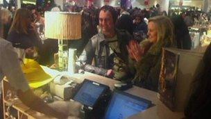 A customers claps at her purchase in Selfridges in the Bullring