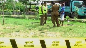 Police examine the resort at Tangalle