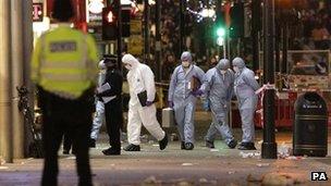 A general view of police at the scene on Oxford Street where a man was stabbed to death today