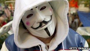 An Occupy protester wears a V for Vendetta mask