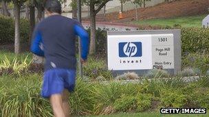 A runner runs past a sign outside HP's headquarters