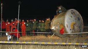 China's unmanned Shenzhou-8 returned to Earth, after completing two space dockings last month