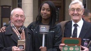 Olympians Harry Reynolds (left) and Tommy Godwin (right) with Amelia Benjamin and the 1948 torch